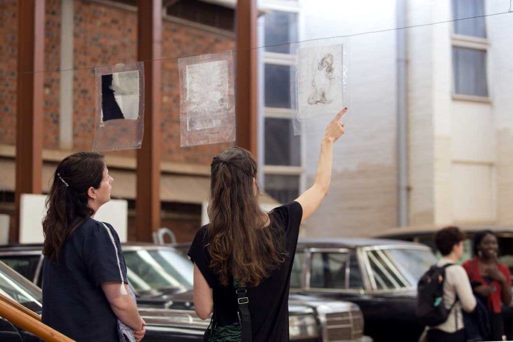 Artist Maria Brinch (on the left) shares story behind some of her work to deputy ambassador of Norway, 2019.