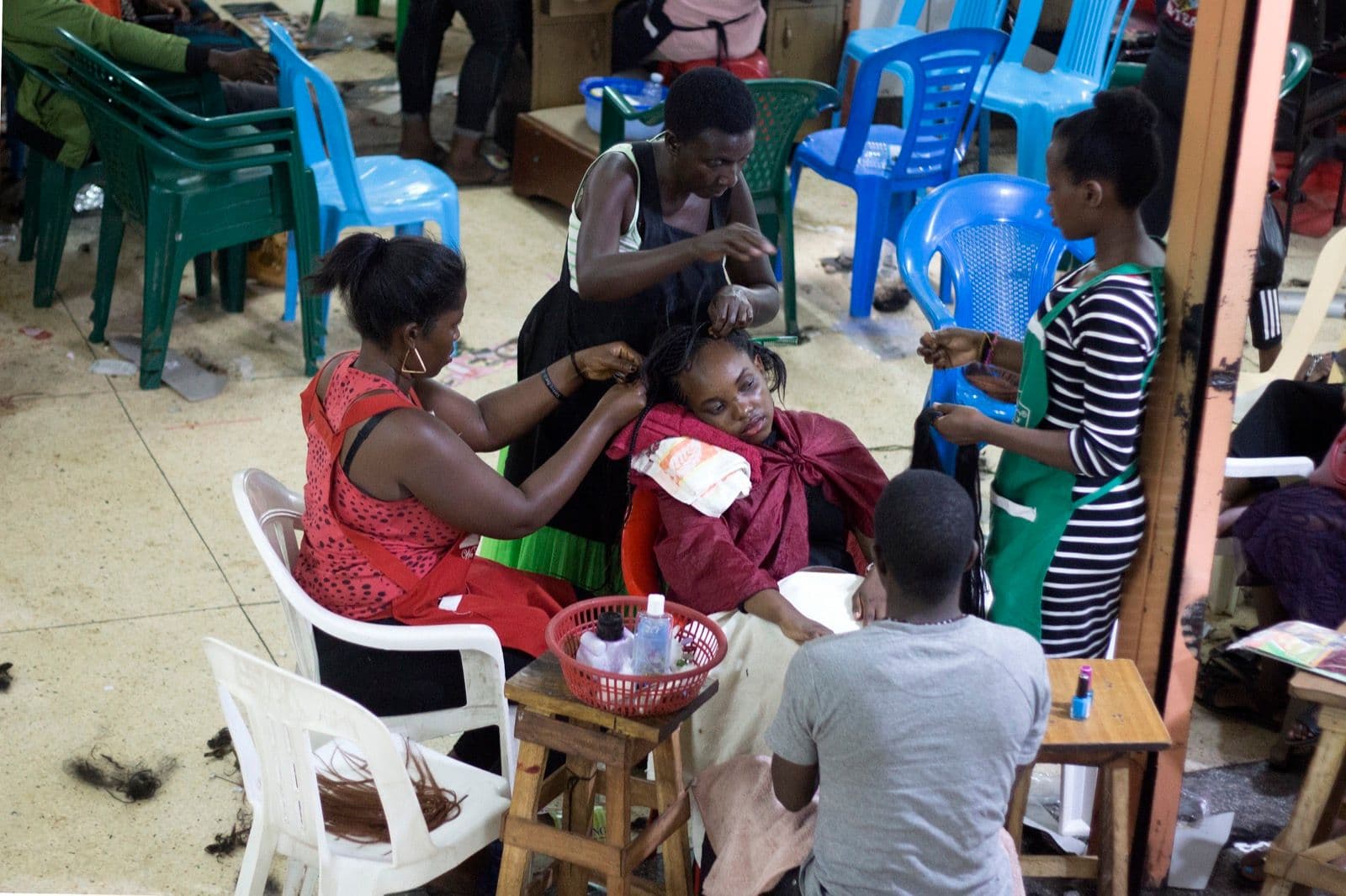 Checking out shades of lipstick at a popular cosmetics corner in downtown, Kampala.