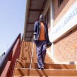 John Ewi, 61, walks down from Lacor Main Wing Hospital in Gulu district, Uganda where he will be undergoing a treatment process to hopefully help him recover and get back on his feet fully.